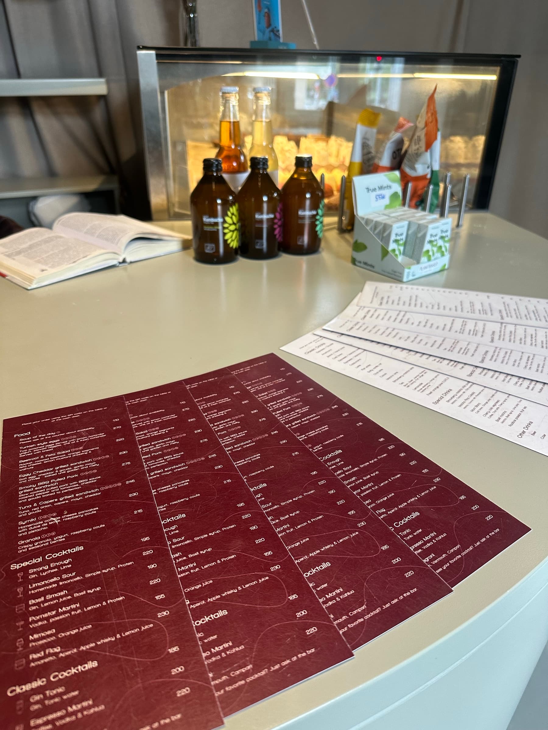 Printed burgundy cocktail menus on the Efsy counter